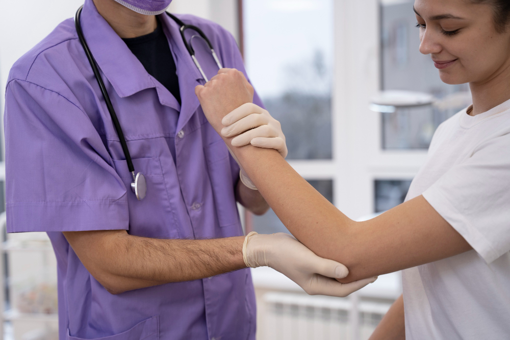 Doctor examining patient legs for vascular conditions including spider veins, varicose veins, and circulation issues in clinic